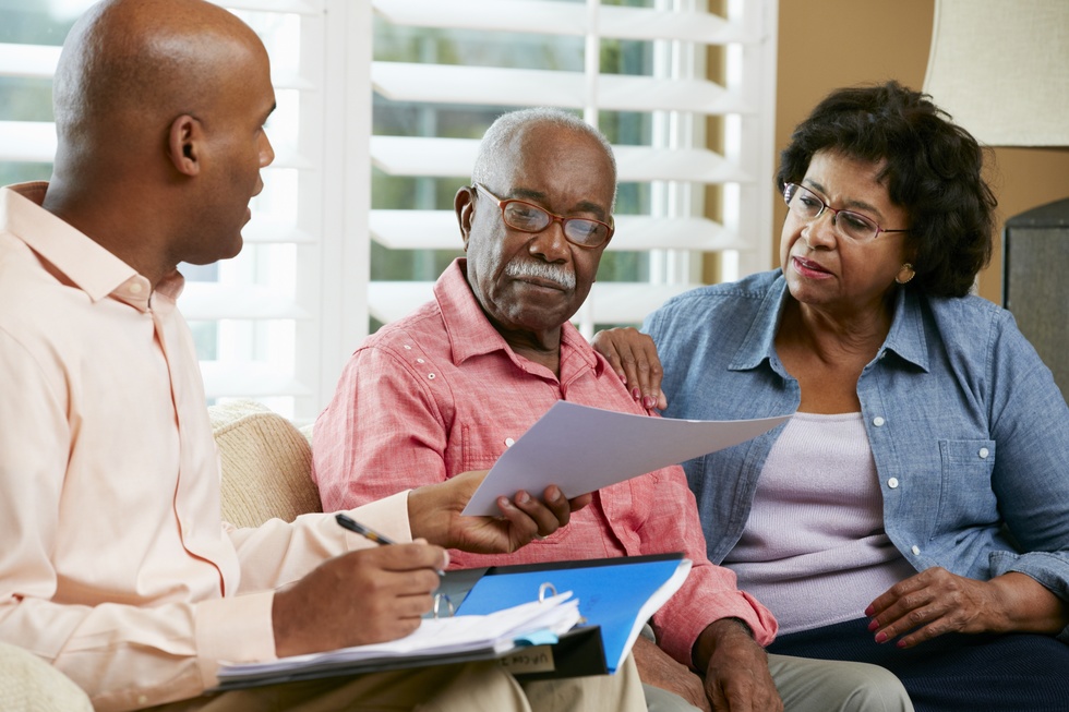 financial advisor talking to senior couple at home