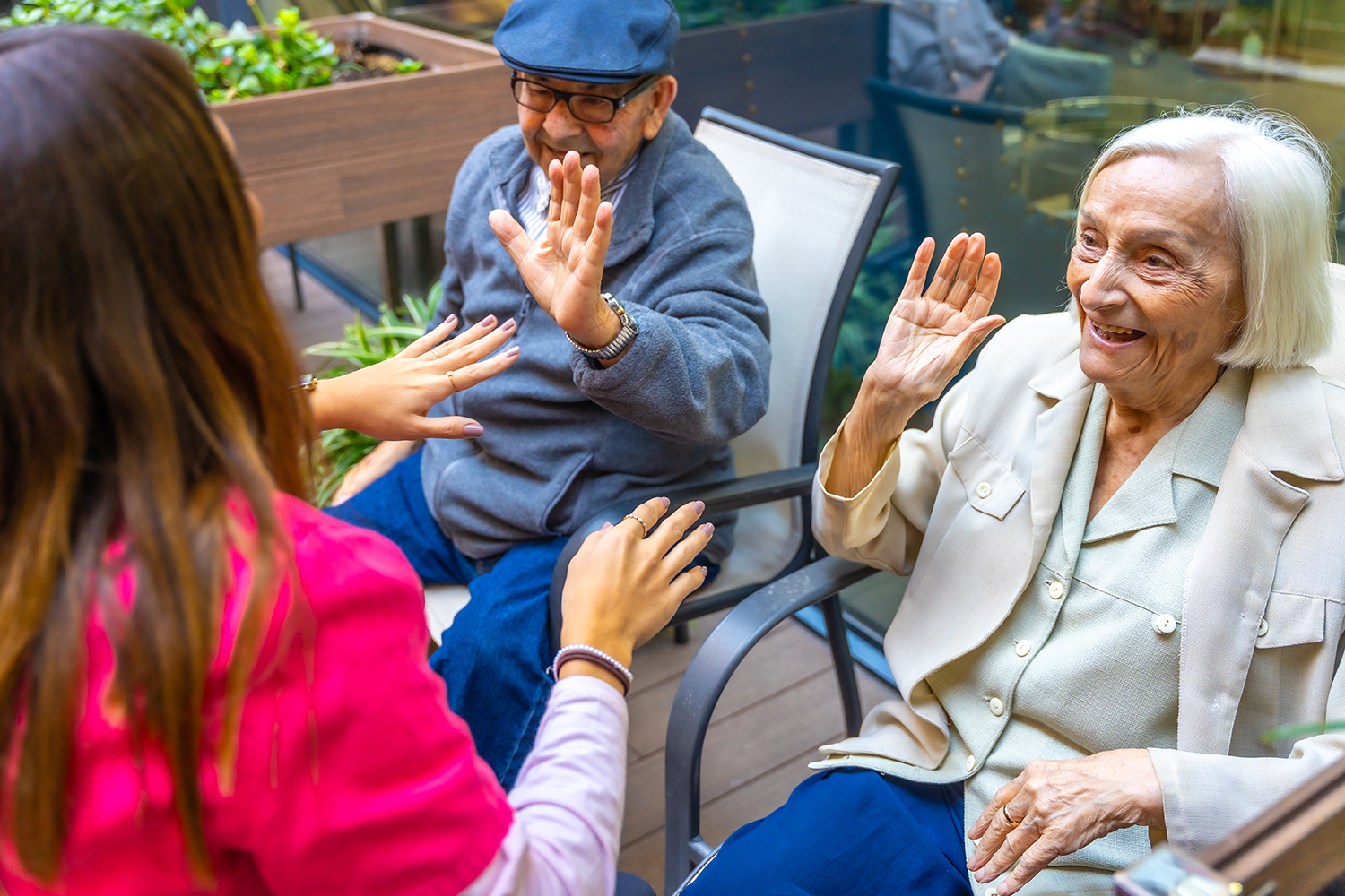 Senior people having fun with a nurse in a geriatric